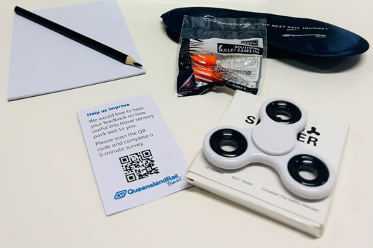 Sensory pack including a soft eye mask, earplugs, a notebook and pencil, and a fidget to spin away stress